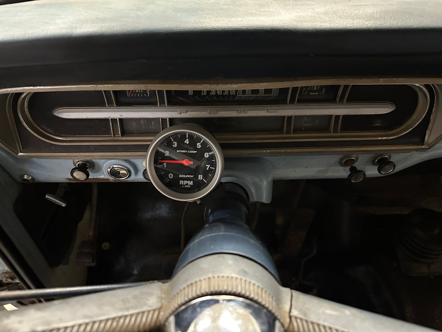 Gauge pod installed on a ford f100. The gauge pod is holding a tachometer